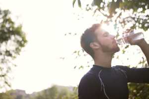 A man drinking from a water bottle