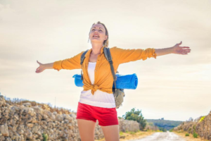 A woman smiling and spreading her arms